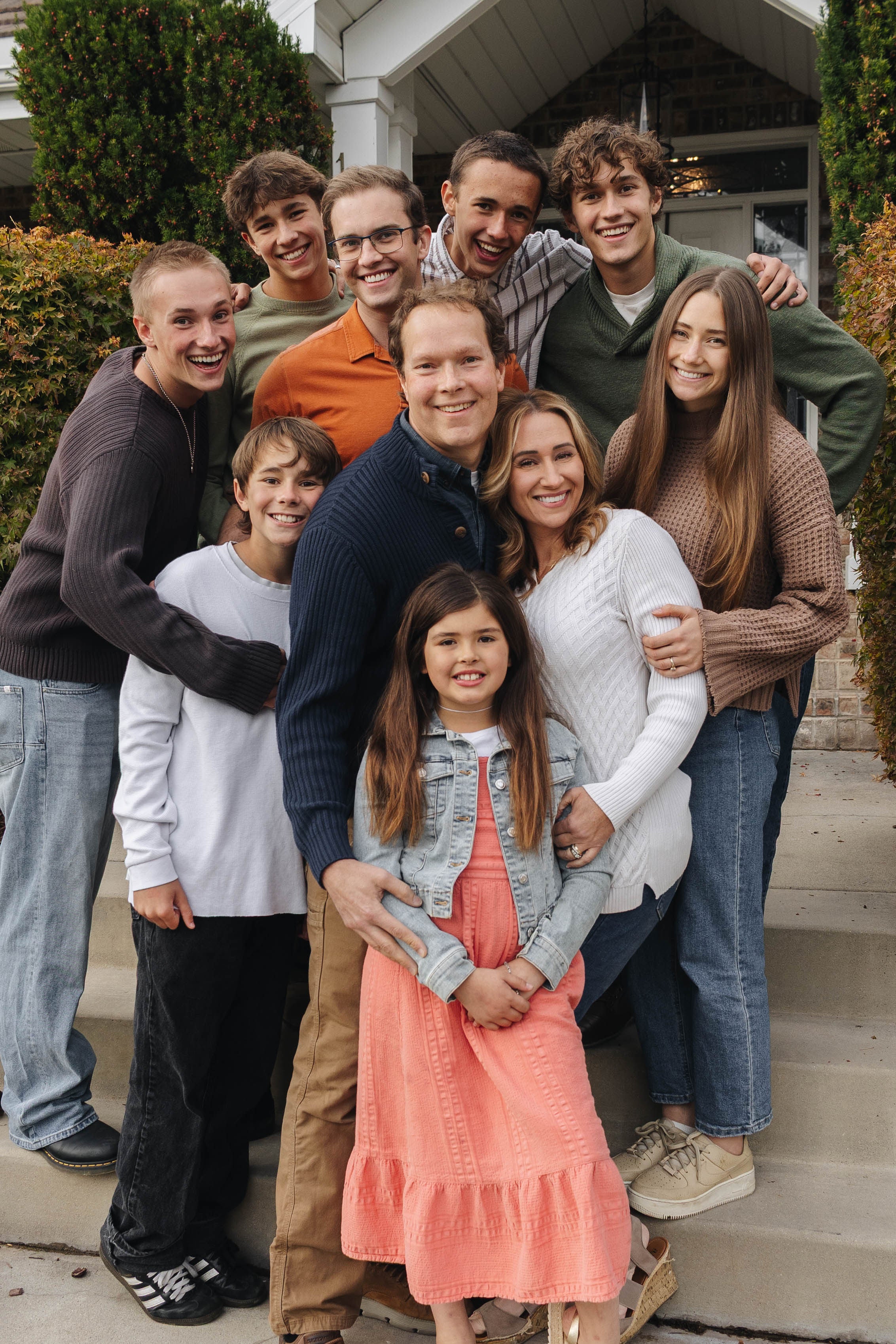 Brigham & Karmel Larson Family posing for a photo on steps outside a house