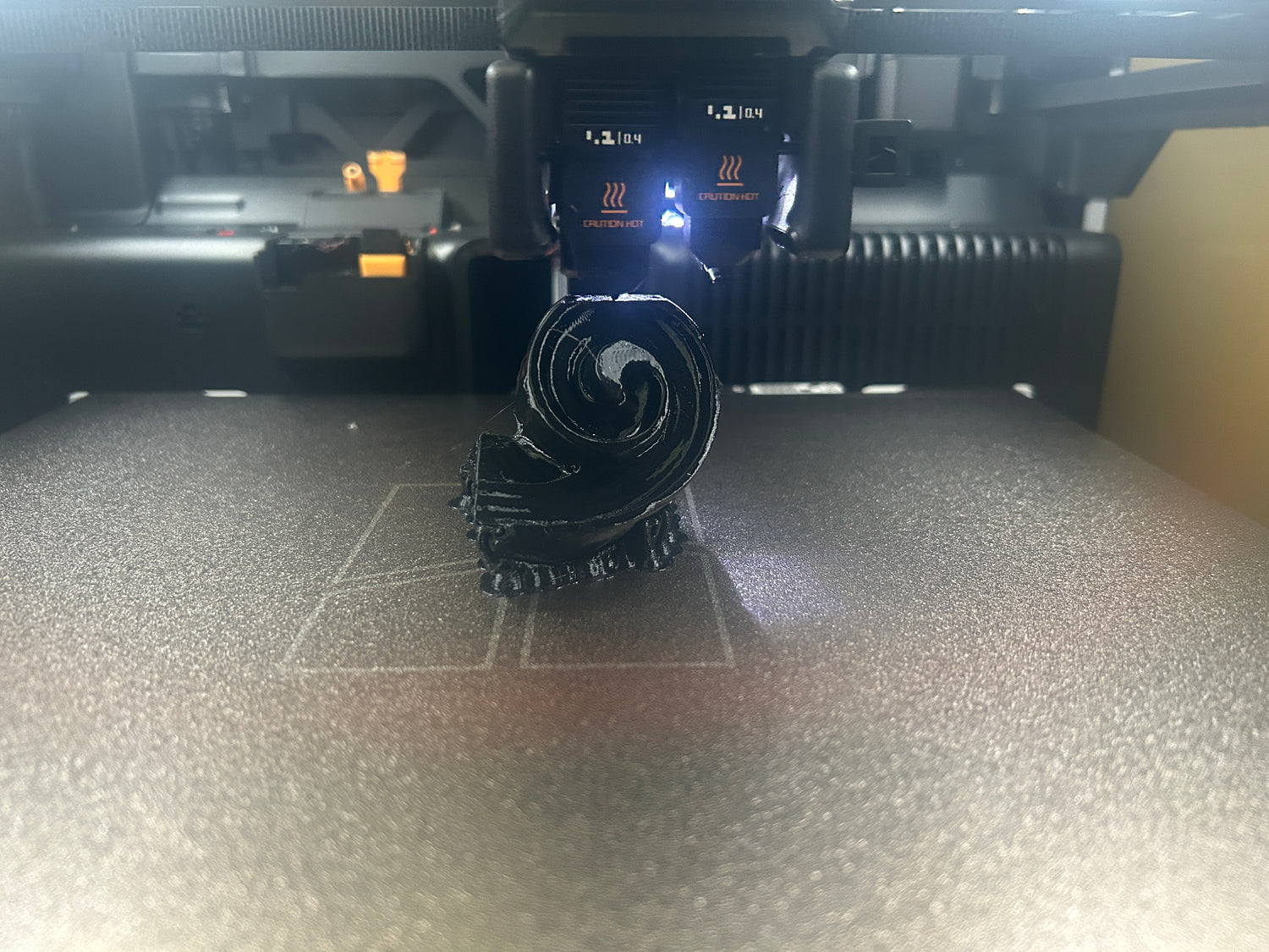 3D printer in operation with filament on a bed at the Brigham Larson Pianos family heirloom piano restoration shop in Orem, UT.