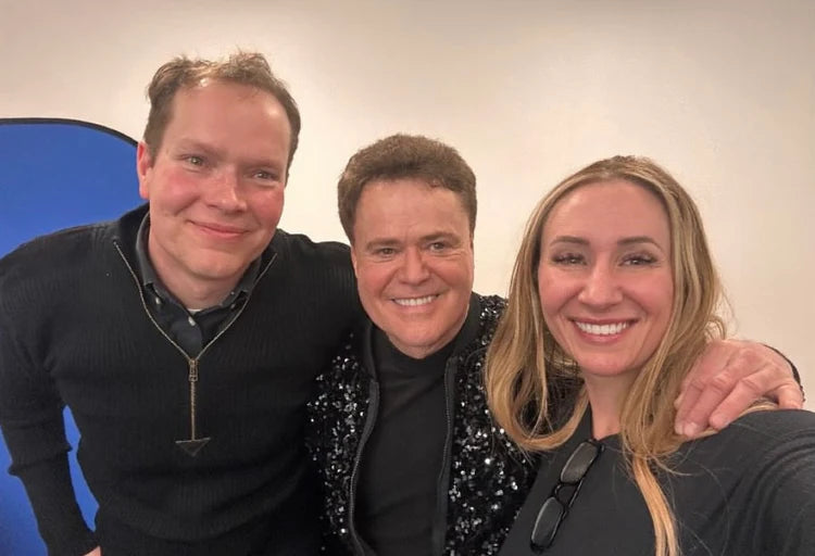 Brigham Larson, Donny Osmond, and Karmel Larson smiling together while posing for a photo after a Las Vegas show, after Brigham transformed Donny's Yamaha C7 concert grand piano into a digital acoustic piano for performance reasons. 