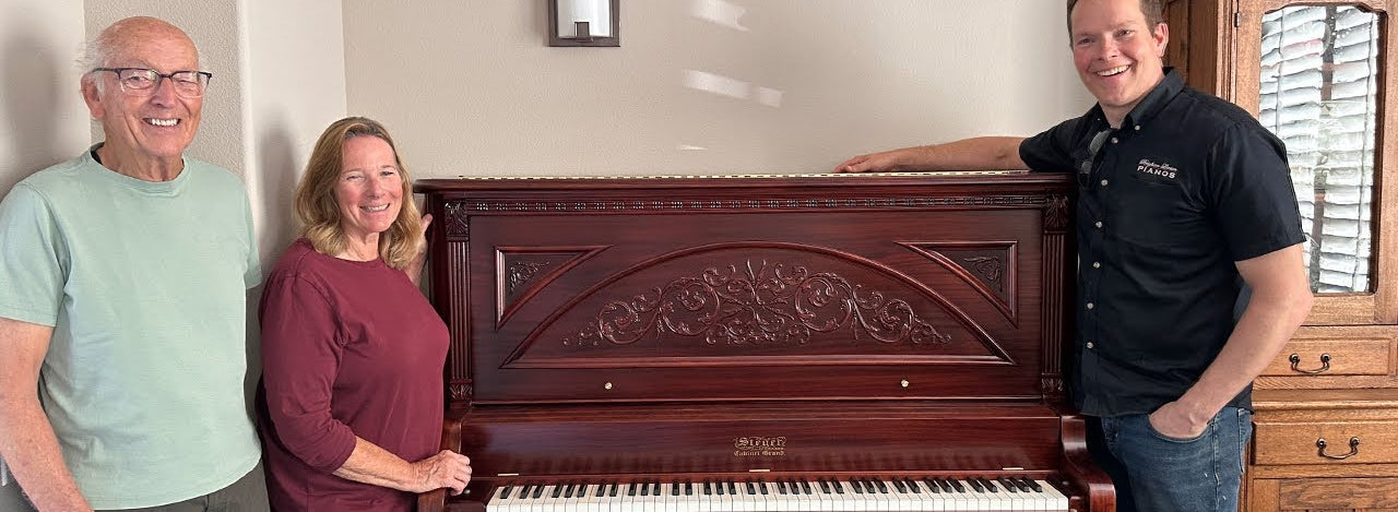 Load video: Brigham Larson with Brigham Larson Pianos delivering fully restored, rebuilt, refinished, like new restored ornate cabinetry sentimental family heirloom Steger upright piano to happy family in California.
