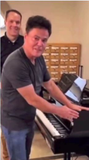 Donny Osmond visits Brigham Larson Pianos piano shop. Brigham shows Donny his  Yamaha C7 grand piano that is being converted into a digital piano for a show.    